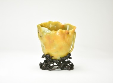 A Finely Carved Yellow Jadeite &lsquo;Lotus Leaf &rsquo; Vase with Wood Stand, Late Qing / Republic.