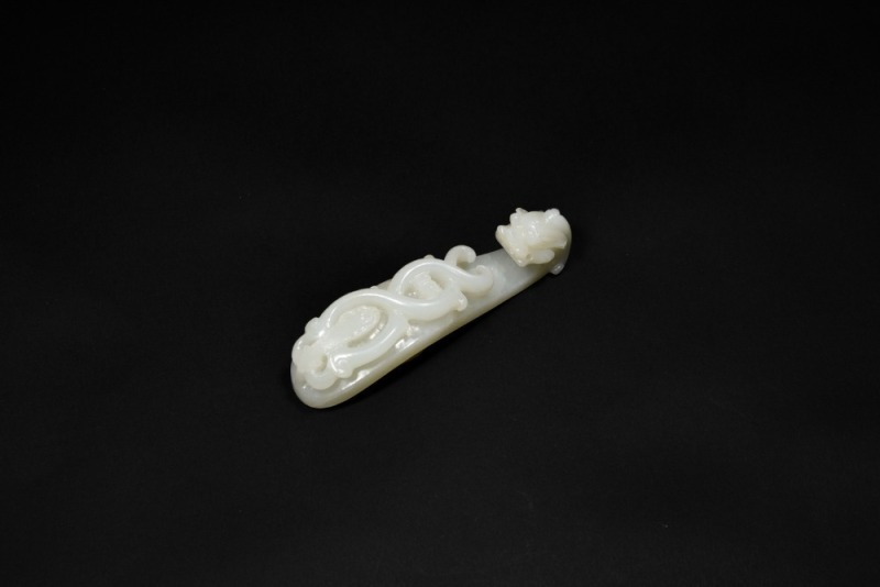 A Finely Carved White Jade Belt Hook with Incised Geometric Decoration, Qianlong Period, (Mid-18th Century)