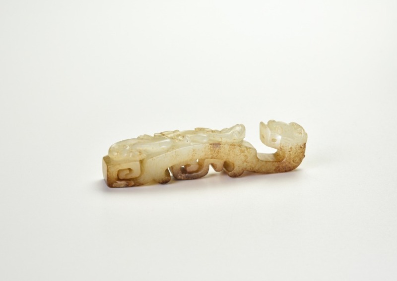 A White Jade Belt Hook with Chilong Design and Russet Inclusions, Western Han Dynasty (2nd Century BC)