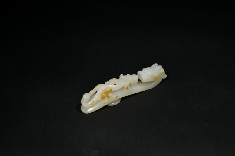 A Fine White Jade Belt Hook with Russet Inclusions and Chilong Design, the Button Carved with Floral Motif, Qing Dynasty, 18th&ndash;19th Century