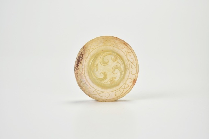A Yellow Jade Bi Disc with Triple Whorl Design, Han Dynasty (circa 2nd Century BC &ndash; 1st Century AD)