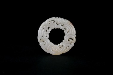 A Reticulated Celadon Jade &lsquo;Dragon&rsquo; Disc. Han Dynasty (206 BC&ndash;AD 220).