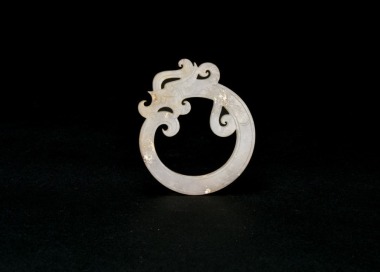 A Celadon Jade &lsquo;Coiled-Tail Dragon&rsquo; Pendant. Han Dynasty (206 BC&ndash;AD 220).