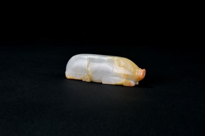 Han Dynasty (206 Bc &ndash; Ad 220). A Celadon-White Jade Recumbent Pig.
