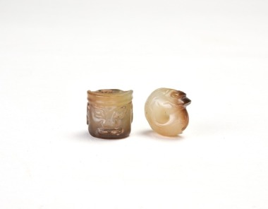 A Jade Tube Bead With Taotie Mask Motif And A Coiled-Dragon Pendant. Shang Dynasty.