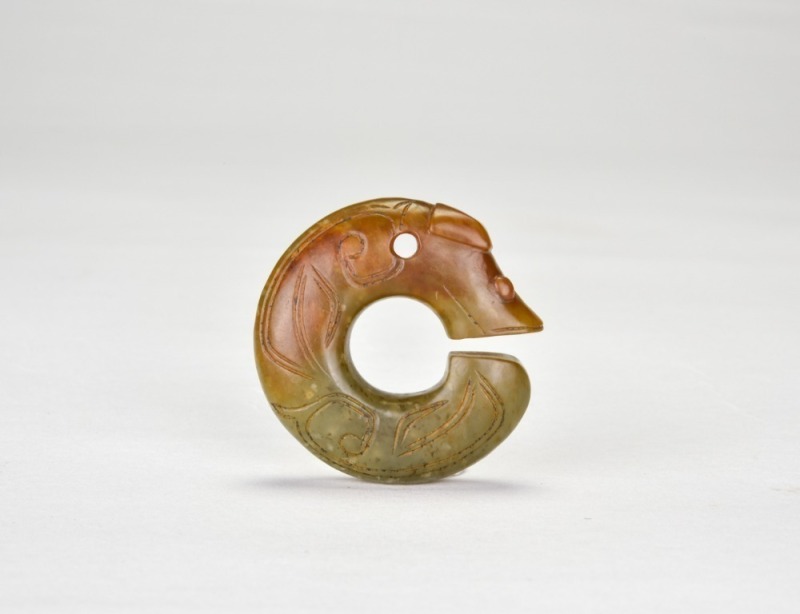 Shang Dynasty (circa 1600&ndash;1046 BC). A Celadon Jade &lsquo;C-Dragon&rsquo; Pendant.