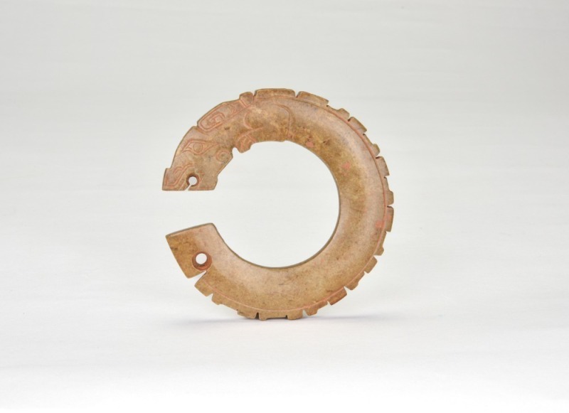 Shang Dynasty. A Jade Dragon-Form Ring Pendant.