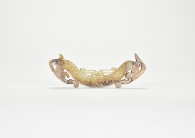 Han Dynasty. Arched Jade Huang with Confronted Double-Dragon Motif.