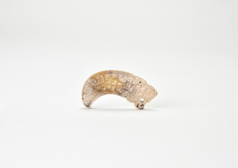Han Dynasty. Arched Jade Pendant with Cloud-and-Dragon Motif.