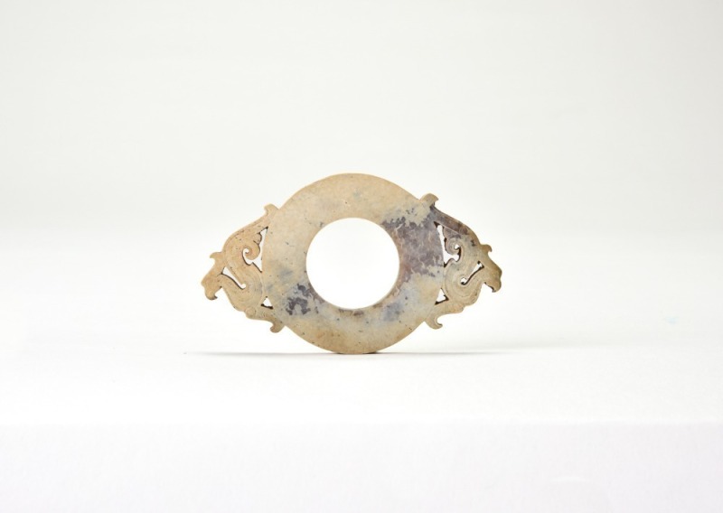 A Han Dynasty Jade Pendant Carved with Confronted Phoenix Motifs.