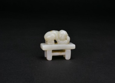A Chinese White Jade Carving of a Boy Holding a Peach of Longevity, Qing Dynasty (circa 18th&ndash;19th century).