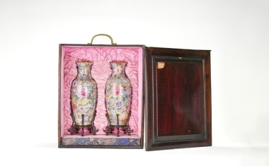 A pair of Chinese Famille-Rose porcelain vases, with dense floral decoration, Late Qing &lsquo;Qianlong Nian Zhi&rsquo; mark, together with original fitted wooden case and fitted wood stand.