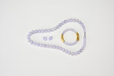 A Group of Lavender Jadeite Jewelry, Comprising a Bead Necklace, Pair of Cabochons, and a Bangle with 14K Gold Clasp.