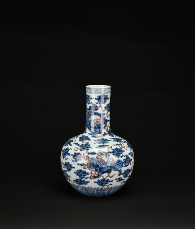 A Blue and Iron-Red &lsquo;Mythical Beast&rsquo; Decorated Long-Neck Vase, Qing Dynasty