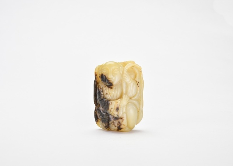 A Black and White Jade Carving of a Boy Holding a Lotus, Late Qing Dynasty / Republican Period