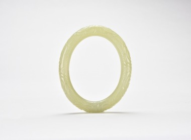 Qing - A Celadon Jade Carved Floral Bangle