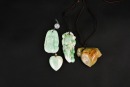 A Group of Four Jadeite Pendants