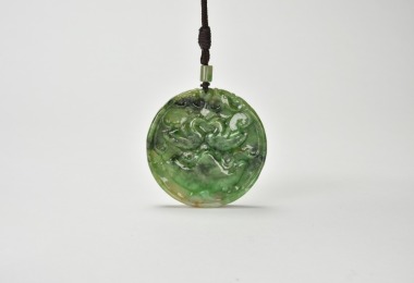 A Jadeite Circular Pendant Carved with Mandarin Ducks