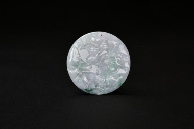A Jadeite Circular Pendant Carved with a Landscape Scene
