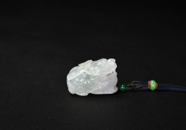 A Carved Translucent Jadeite Dragon Pendant