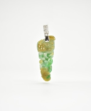 A Carved Jadeite Dragon Pendant with Russet and Emerald Inclusions