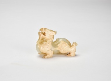 A Carved Pale Celadon Jade Figure Of A Winged Mythical Beast, Han Dynasty