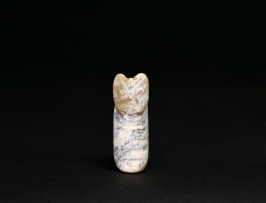 A Mottled Jade Animal-Form Tubular Pendant, Shang Dynasty