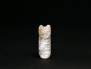 A Mottled Jade Animal-Form Tubular Pendant, Shang Dynasty