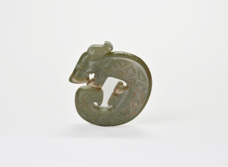 A Carved Jade Coiled-Tail Dragon Pendant, Shang Dynasty