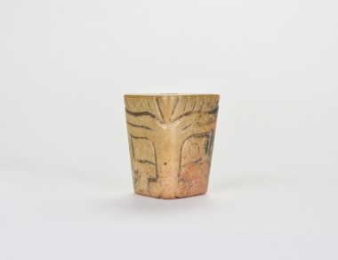 A Carved Triangular Jade Tubular Ornament with Stylized Mask Design, Liangzhu Culture