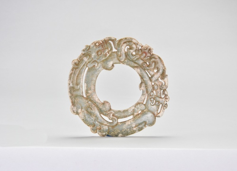 A Carved Celadon Jade Openwork Dragon-and-Phoenix Bi Disc, Warring States Period