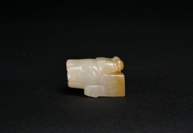 A Pale Celadon Jade Carving of a Recumbent Mythical Beast, Shang Dynasty