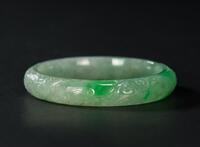 A Semi Translucent Apple Green Jadeite Carved ‘Dragon And Phoenix’ Bangle