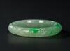 A Semi Translucent Apple Green Jadeite Carved ‘Dragon And Phoenix’ Bangle