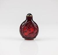 A Red Glass Carved Chilong Snuff Bottle