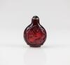 A Red Glass Carved Chilong Snuff Bottle