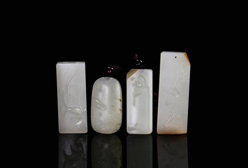 A Group of Four Fine White Jade Carved ‘Flowers’ Pendants