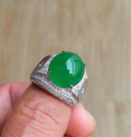 A Large Top Quality Natural Intense Emerald Green Jadeite Diamond Ring.