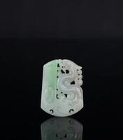 A Translucant Green Jadeite Carved Dragon And Shou’ Pendant