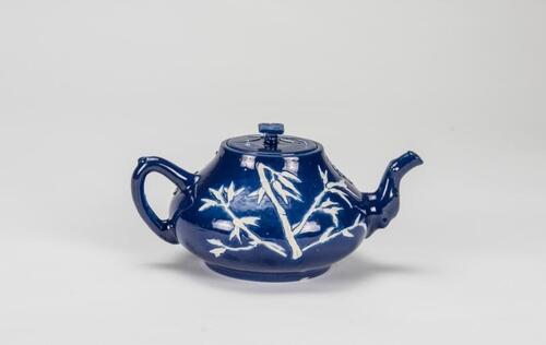 Qing - A Blue Ground Carved 'Plum Flower' Tea Pot