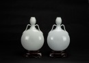 Qing - A Pair Of White Glazed Carved ‘Flowers’ Moonflask (Woodstand)