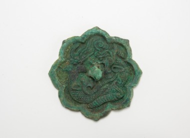 Tang Dynasty- A Bronze Foliate-Rim ‘Dragon’ Mirror