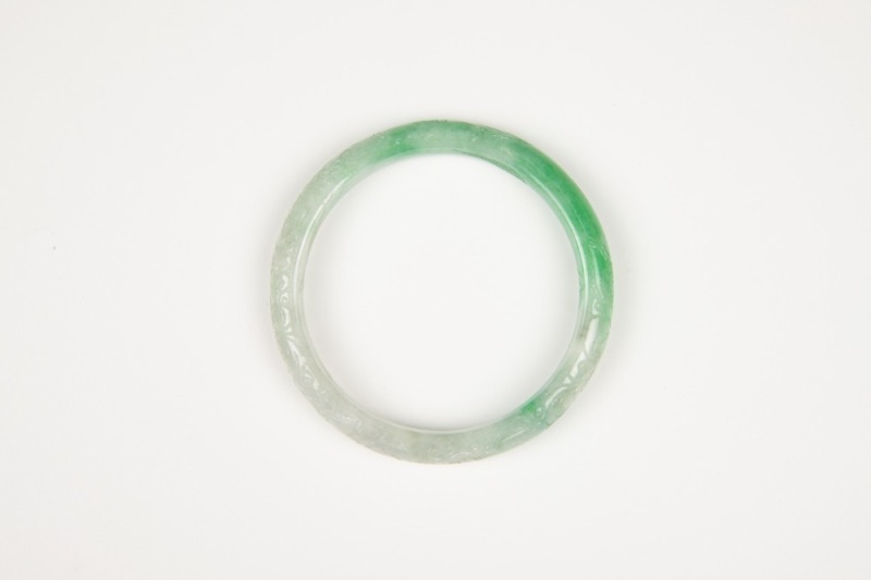 A Semi-Translucent Green Jadeite Carved ‘ Flowers’ Bangle