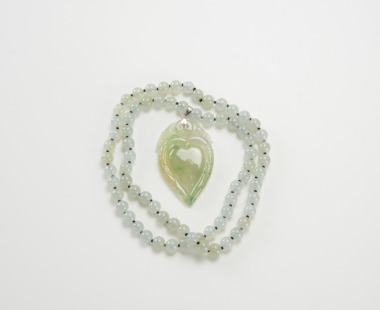 A Semi-Translucent Jadeite Beads Necklace And Jadeite Hartshape Pendant