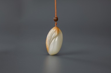 Qing-A Russet White Jade Carved ‘Melon’ Pendant