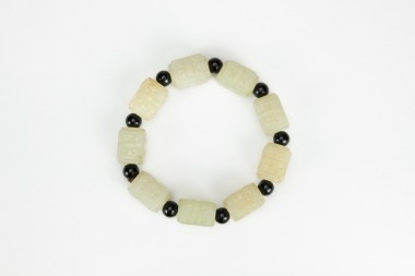 A Chinese White Jade Carved Nine Small Cong Shape Bracelet