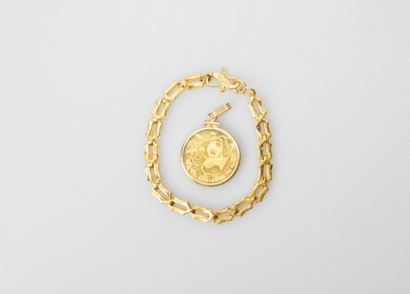 A 0.25 0z Panda Gold Coin Pendant And 24k Gold Bracelet