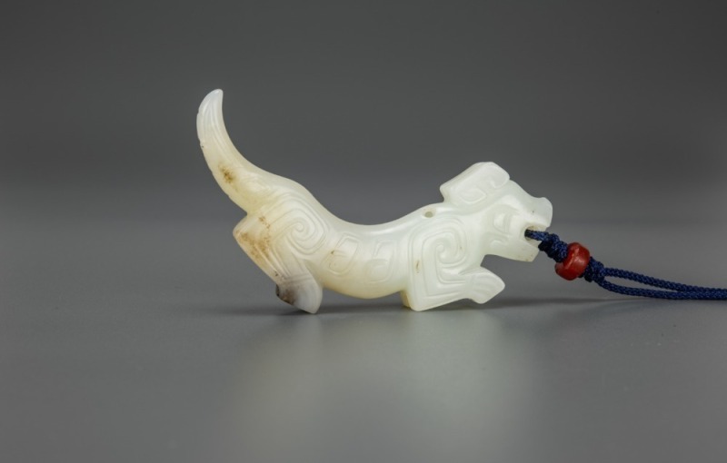 A White Jade Carved Tiger Pendant
