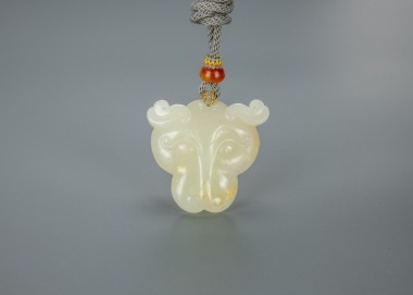 A Chinese White Jade Carved Leopard Face Pendant