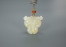 A Chinese White Jade Carved Leopard Face Pendant